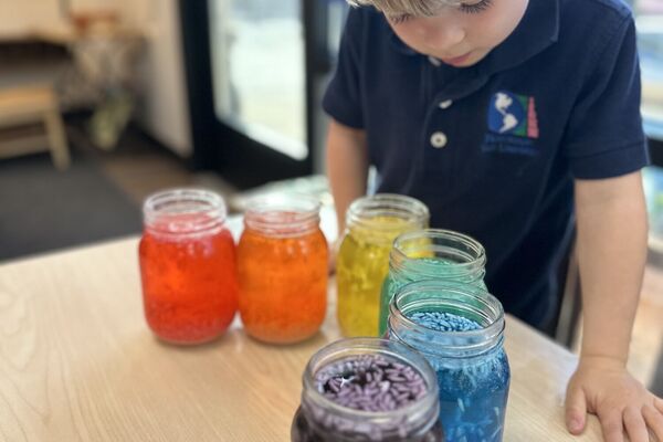 Child exploring colorful sensory materials in Reggio inspired learning