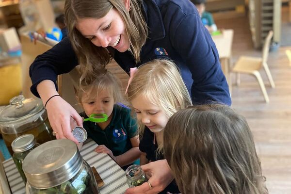 Teacher and children exploring nature and science enrichment activities